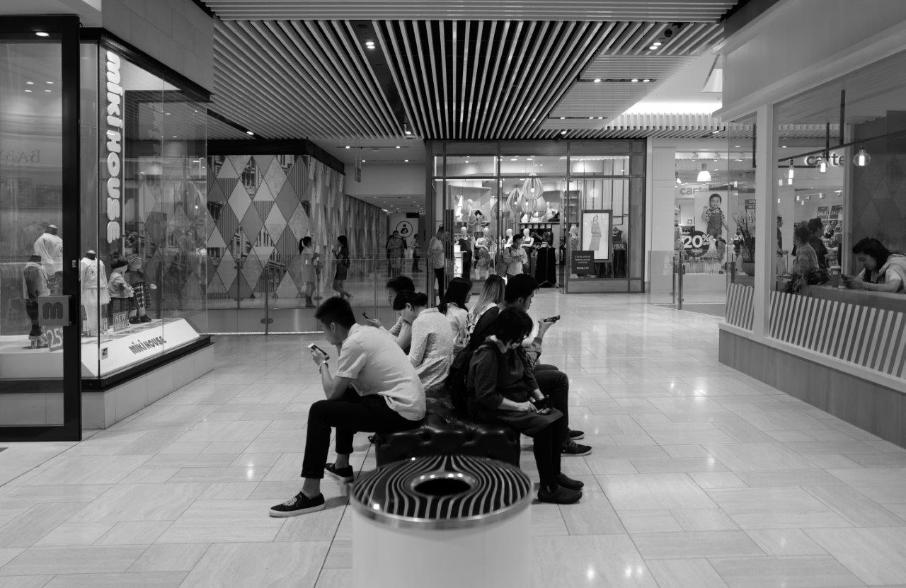 people looking at devices in the emporium shopping centre, melbourne